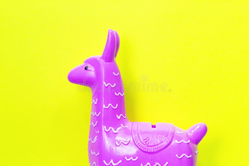 Testa porpora rosa del lama del giocattolo su fondo giallo fotografia stock Testa porpora rosa del lama del giocattolo su fondo giallo fotografia stock