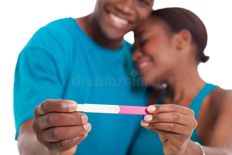 African couple showing pregnancy test over white background. African couple showing pregnancy test over white background