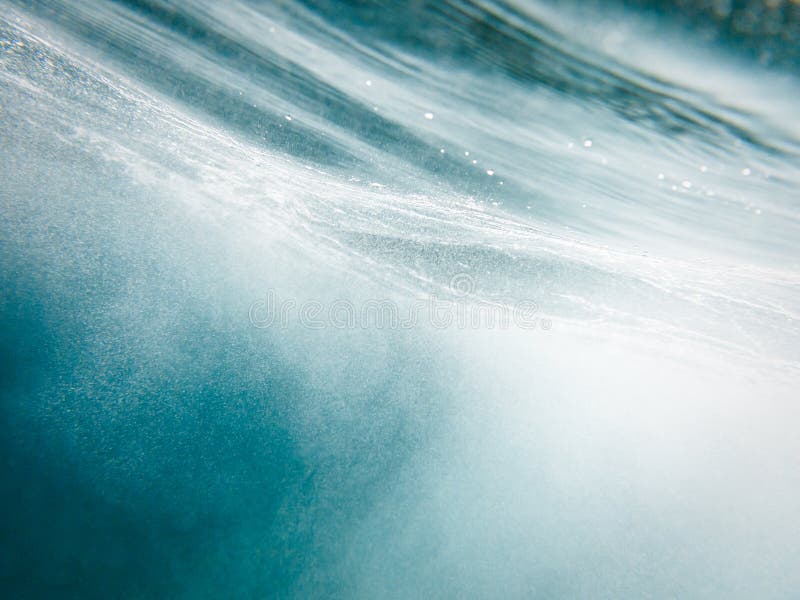 Abstract clear turquoise blue horizontal streaked water pattern with air bubbles from underwater. Abstract clear turquoise blue horizontal streaked water pattern with air bubbles from underwater