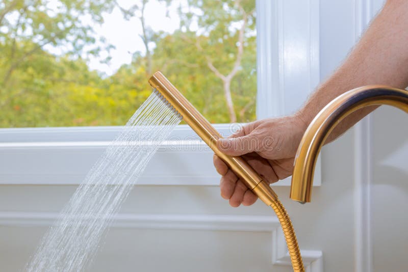 Shower head with water stream in domestic bathroom, bathtub, showering, hygiene, hand, modern, clean, wet, spray, home, closeup, liquid, health, object, cold, white, wall, flowing, fresh, drop, hot, wash, metal, equipment, bright, droplet, shiny, motion, healthy, , hose, plumbing, splash, falling, jet, single, pouring, washing, household, faucet, splashing, interior, showerhead, installation. Shower head with water stream in domestic bathroom, bathtub, showering, hygiene, hand, modern, clean, wet, spray, home, closeup, liquid, health, object, cold, white, wall, flowing, fresh, drop, hot, wash, metal, equipment, bright, droplet, shiny, motion, healthy, , hose, plumbing, splash, falling, jet, single, pouring, washing, household, faucet, splashing, interior, showerhead, installation