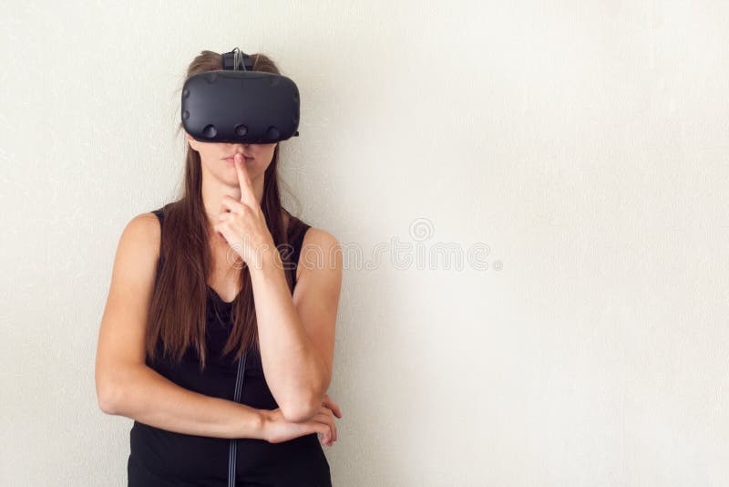 Testing new technologies. Attractive young woman in VR headset gesturing. royalty free stock photo Testing new technologies. Attractive young woman in VR headset gesturing. royalty free stock photo