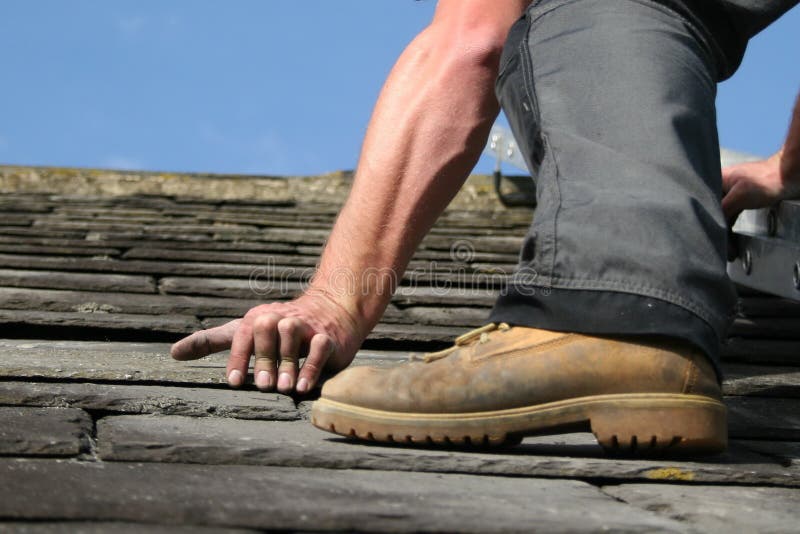 Man replacing a slate on a roof. Man replacing a slate on a roof