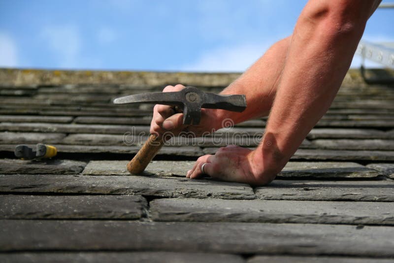 Man replacing a slate on a roof. Man replacing a slate on a roof
