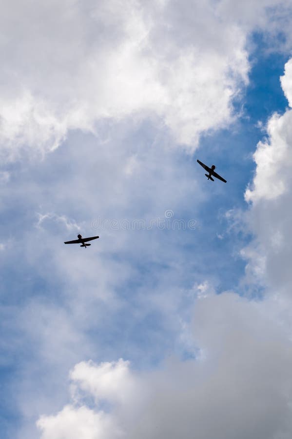 EDEN PRAIRIE, MN - JULY 16, 2016: AT6 Texan plane peels off from formation at air show. The AT6 Texan was primarily used as trainer aircraft during and after World War II.