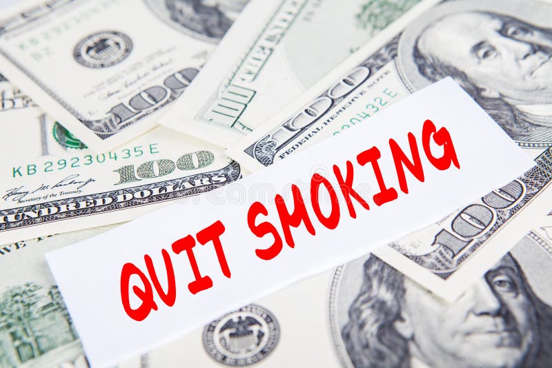 Text of quit smoking on the paper with dollars money on the background. Text of quit smoking on the paper with dollars money on the background
