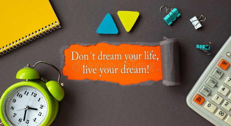 Text Don t dream your life, live your dream it appearing behind torn brown paper. Motivation quote. Text Don t dream your life, live your dream it appearing royalty free stock image