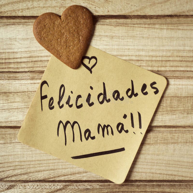 Text felicidades mama, congrats mom in spanish. Closeup of a piece of paper with the text felicidades mama, congrats mom written in spanish and a heart-shaped stock photography