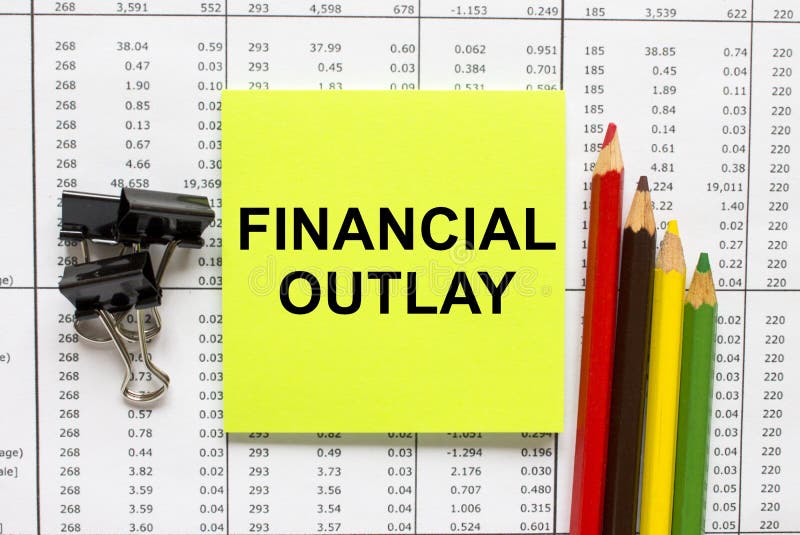 Text Financial Outlay on financial tables with pencils, glasses and paper clips