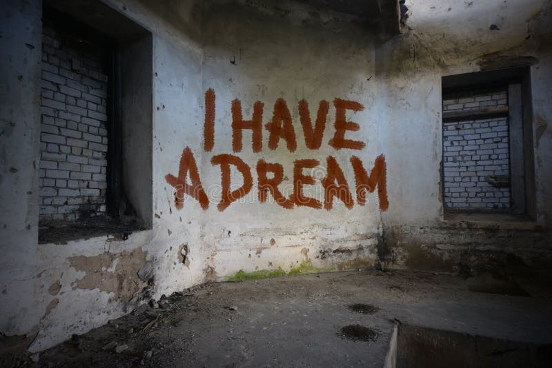 Text i have a dream on the dirty old wall in an abandoned house