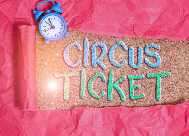 Text sign showing Circus Ticket. Business photo showcasing card that gives the holder a certain right to enter the circus Alarm clock and torn cardboard placed above a wooden classic table backdrop. Text sign showing Circus Ticket. Business photo showcasing card that gives the holder a certain right to enter the circus Alarm clock and torn cardboard placed above a wooden classic table backdrop