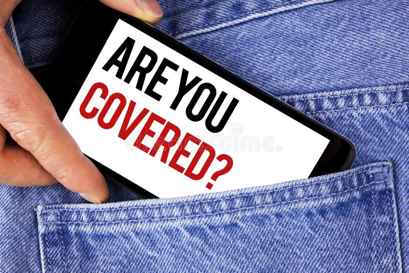 Text sign showing Are You Covered Question. Conceptual photo Health insurance coverage disaster recovery written Mobile phone holding by man the Blue Jeans background. Text sign showing Are You Covered Question. Conceptual photo Health insurance coverage disaster recovery written Mobile phone holding by man the Blue Jeans background.