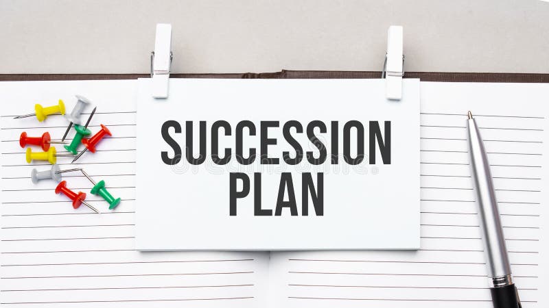 Text SUCCESSION PLAN on stickers on the diary with office tools royalty free stock photos