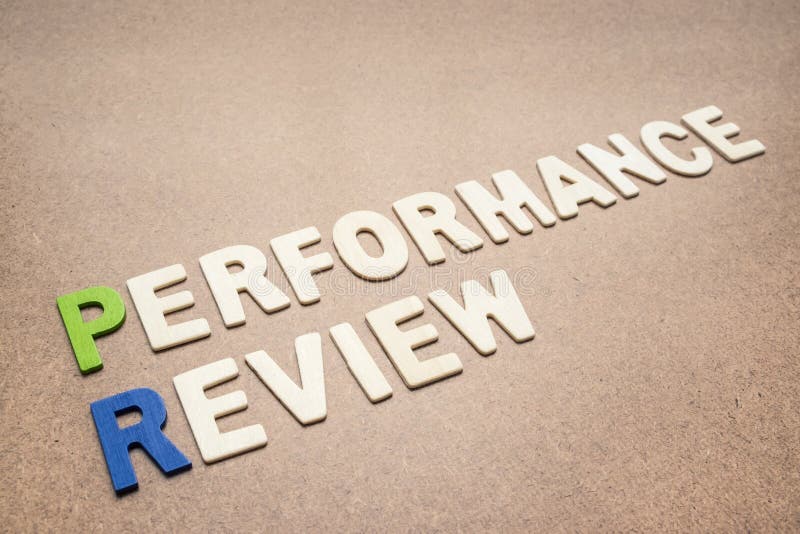 Texte d'évaluation des performances sur le fond brun images stock Texte d'évaluation des performances sur le fond brun images stock