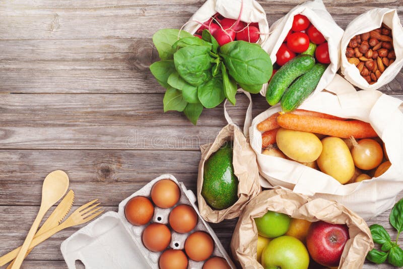 Textile and paper bags with vegetables and fruits and reusable bamboo kitchen utensils. Zero waste food shopping, eco friendly royalty free stock photo Textile and paper bags with vegetables and fruits and reusable bamboo kitchen utensils. Zero waste food shopping, eco friendly royalty free stock photo