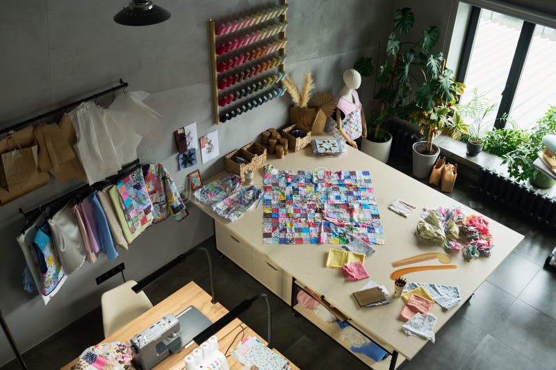 Textile Workshop Showing Large Table Covered with Colorful Fabric Swatches stock images