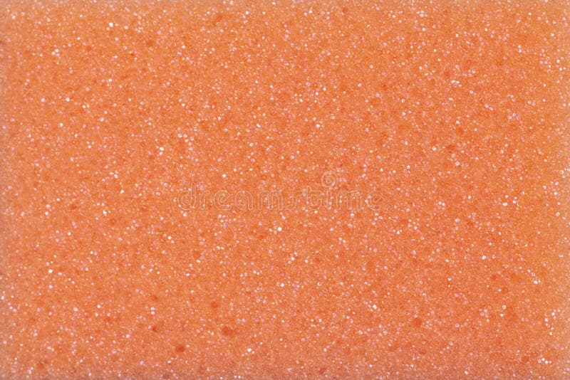 textura de fondo de una esponja naranja con partículas brillantes cierre de un poroso