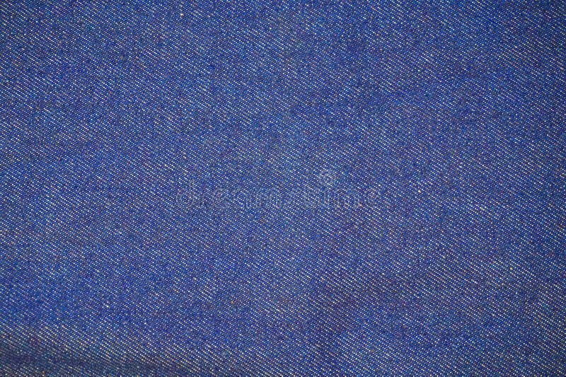 Textura del algodón de los tejanos. Los vaqueros texturizan - el fondo azul del algodón