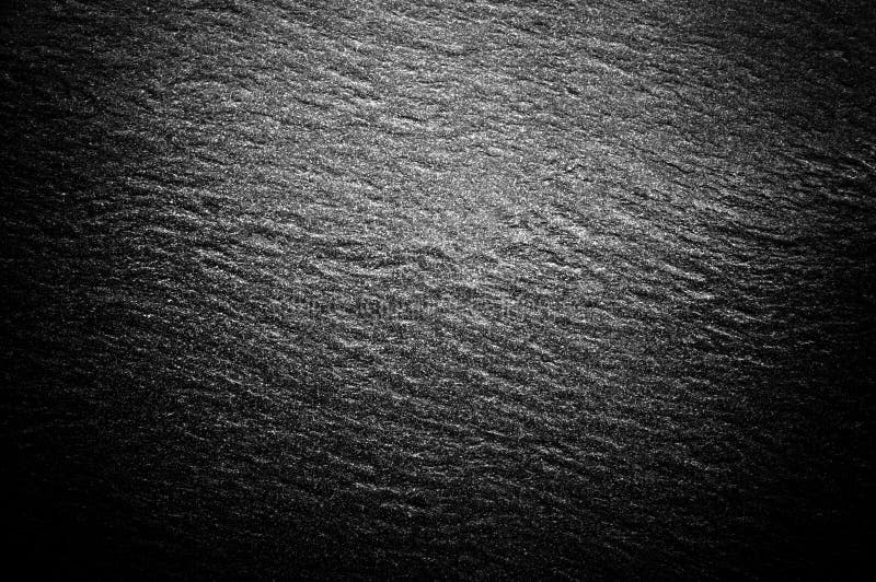 Textura preta da parede de pedra Superfície marcada áspera com especs. brancas fotografia de stock royalty free Textura preta da parede de pedra Superfície marcada áspera com especs. brancas fotografia de stock royalty free