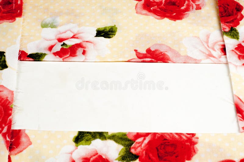 Texture, background, pattern. Silk fabric is beige with red rose