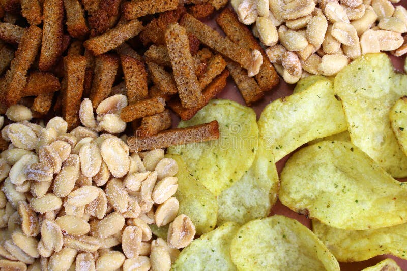 Texture of beer snacks chips, crackers and nuts salted peanuts stock photography Texture of beer snacks chips, crackers and nuts salted peanuts stock photography