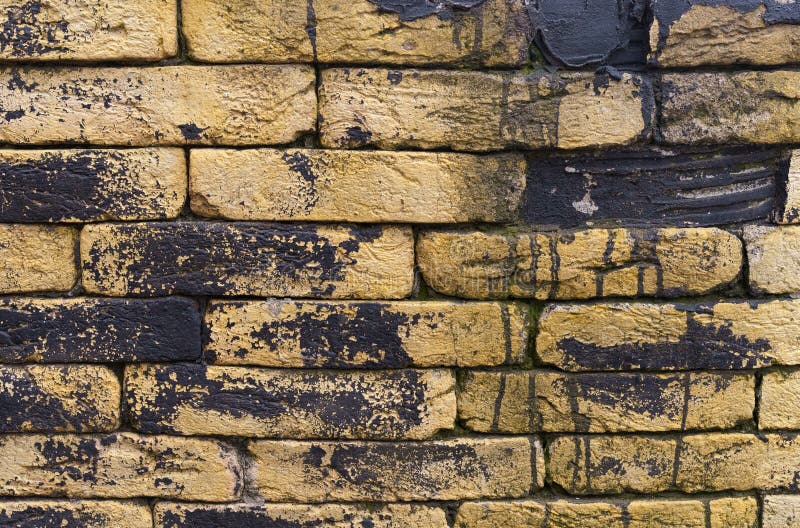 Texture of a Brick Wall with Black Paint Totec Elements. Stock Image