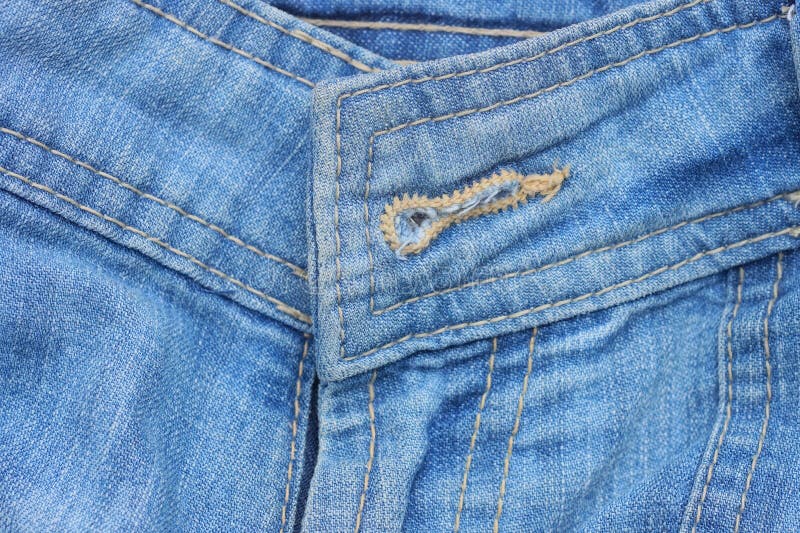 Texture of buttonhole on blue cotton denim stock photo