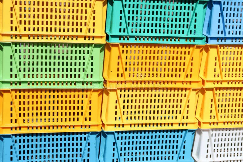 Texture from colored plastic colored yellow blue green rectangular boxes with holes for goods, bottles royalty free stock photos
