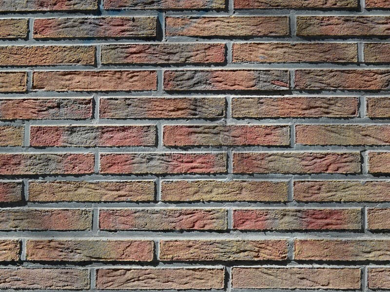 Texture of a decorative multicolored tinted stucco imitating brickwork stock images