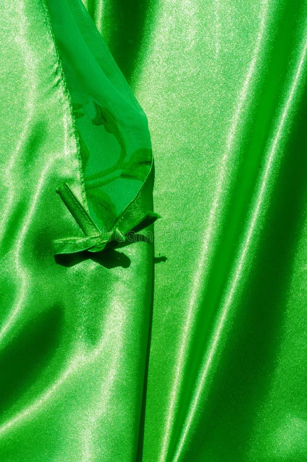 Texture, fabric, background. Abstract background of luxurious fabric or liquid waves or wavy grunge crease silk satin texture of velvet material or luxurious Christmas or elegant background. green