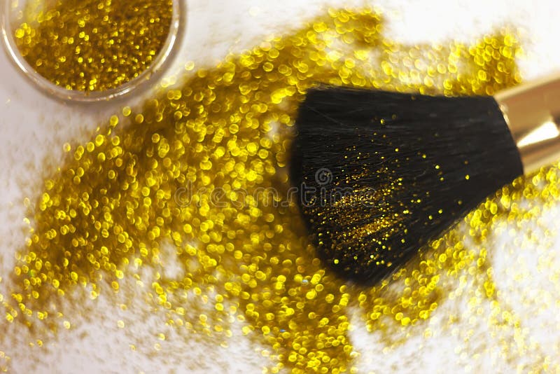 Texture of Gold Glitter on the Makeup Brush and Design. on White