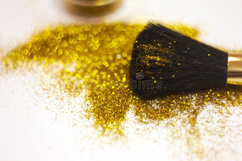 Texture of Gold Glitter on the Makeup Brush and Design. on White