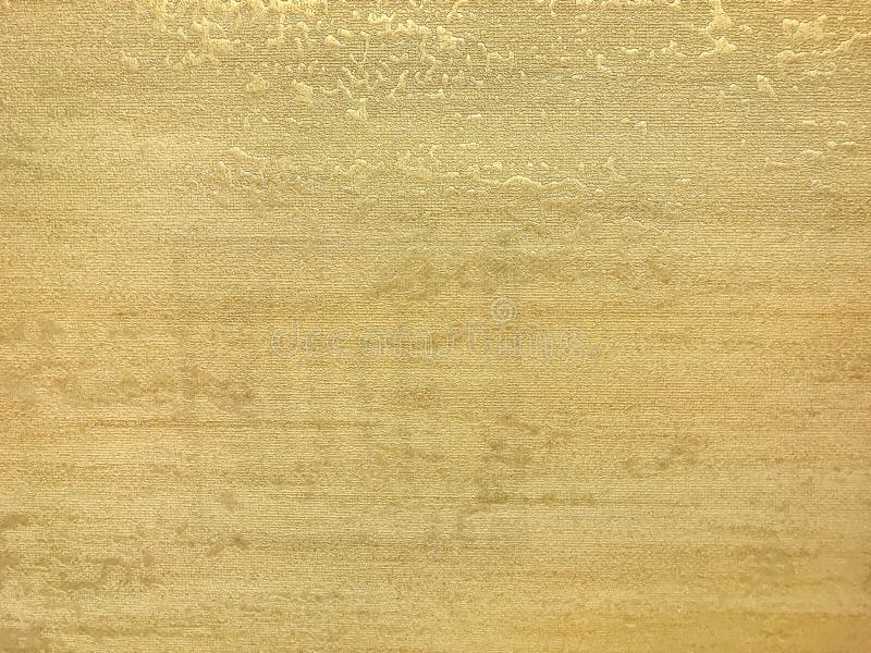 Texture of golden wallpaper with a pattern. Yellow paper surface, structure closeup stock photo
