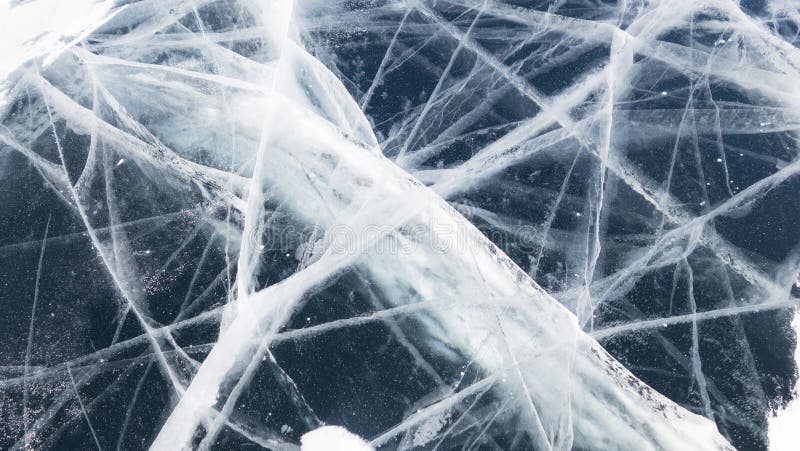 Texture of ice of Baikal lake in Siberia. Dark blue ice surface pattern. ice and cracks on the surface of Lake Baikal stock photography