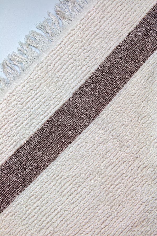 The Texture of a Light Beige with a Brown Stripe Bath Towel with a