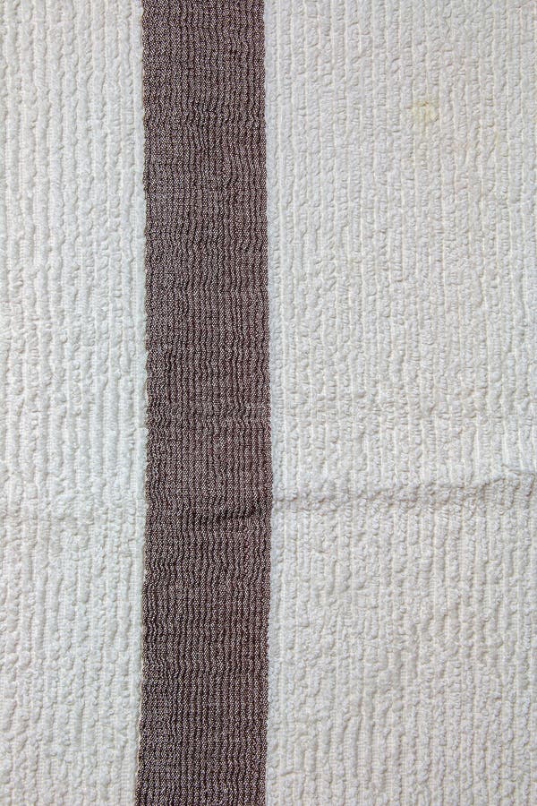 The Texture of a Light Beige with a Brown Stripe Bath Towel with a