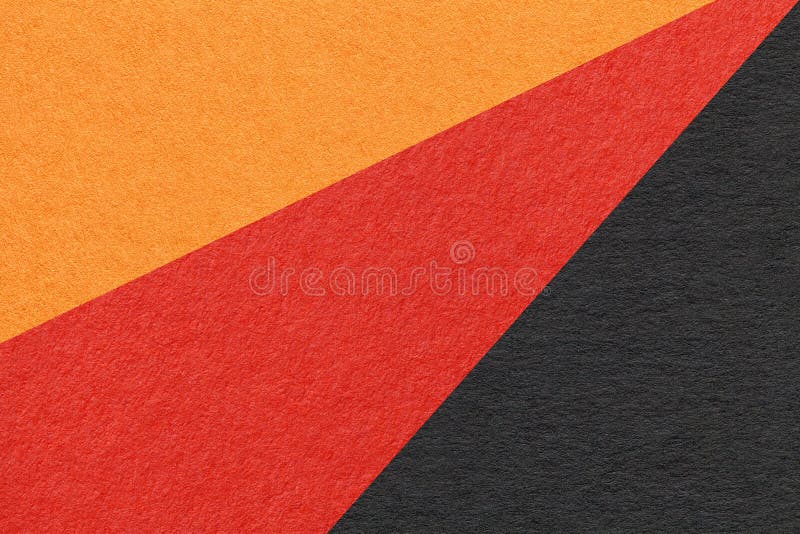 Texture of old craft red, black and orange color paper background, macro. Vintage abstract cardboard. Structure of vintage abstract cardboard with gradient and rainbow pattern. Felt backdrop closeup.