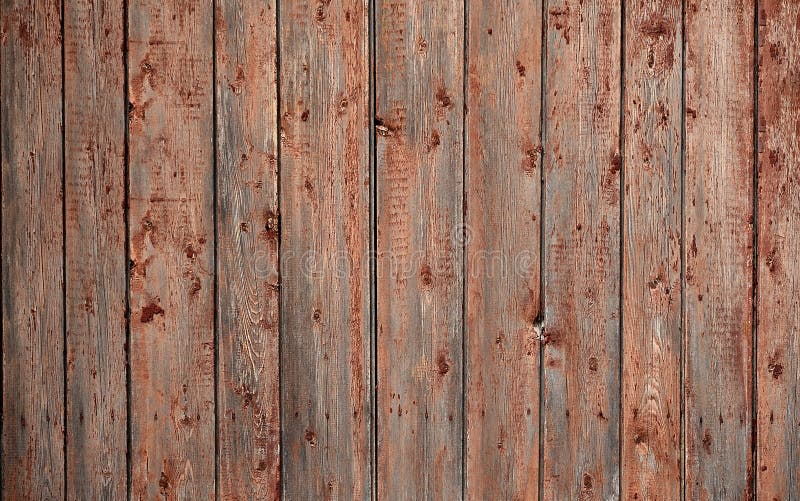 The texture of an old rustic wooden fence made of flat processed boards. Detailed image of a street fence of a rustic type made o
