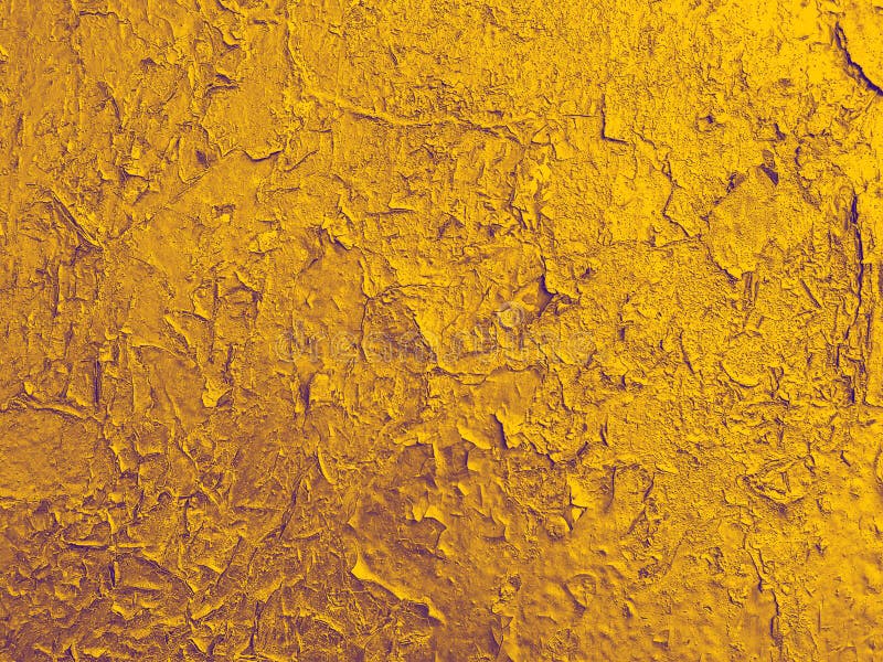 Texture of old wall with a cracked golden paint.