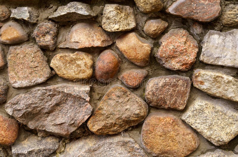 The texture of the old wall of large cobblestones. stock image