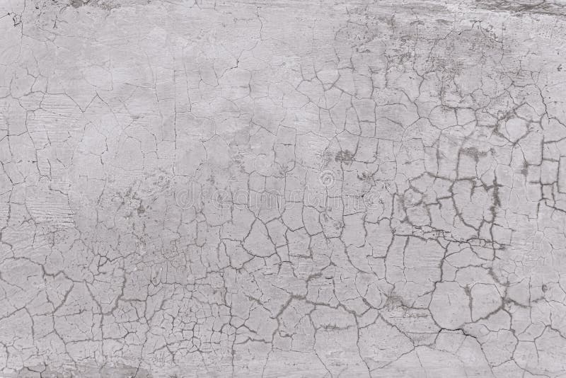 Texture of an old white wall with a lot of cracks stock photos