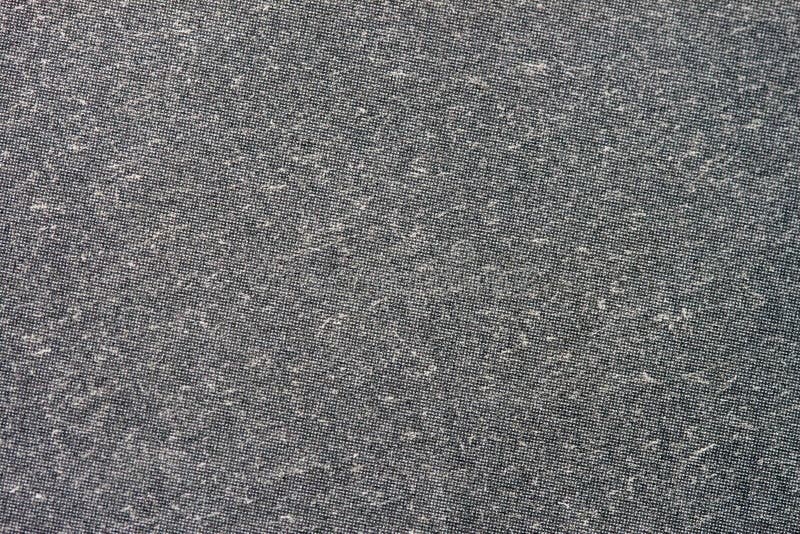 Texture of organic dark grey paper for artwork with numerous natural inclusions. Modern dark background, backdrop stock image