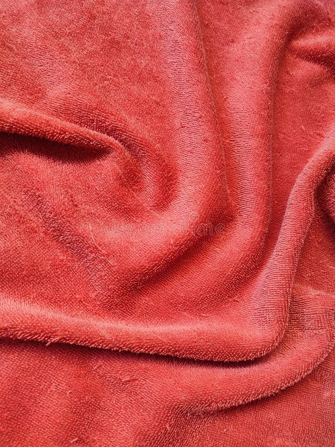 Texture, pattern, background of red towel exposed to sunlight