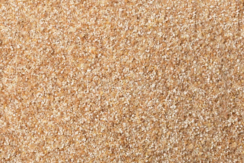 texture of raw wheat grits background.