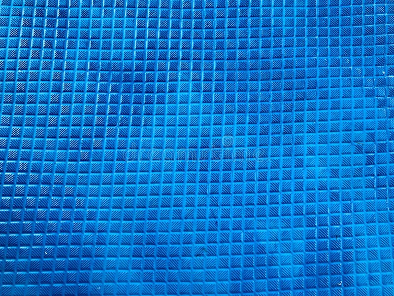 Texture rubber non-slip blue mat with a pattern of square small tiles. The background stock photography