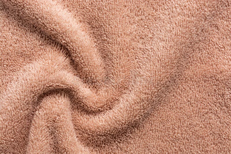 Texture of soft terry fabric in beige, swirl. Terry towel close-up royalty free stock photo