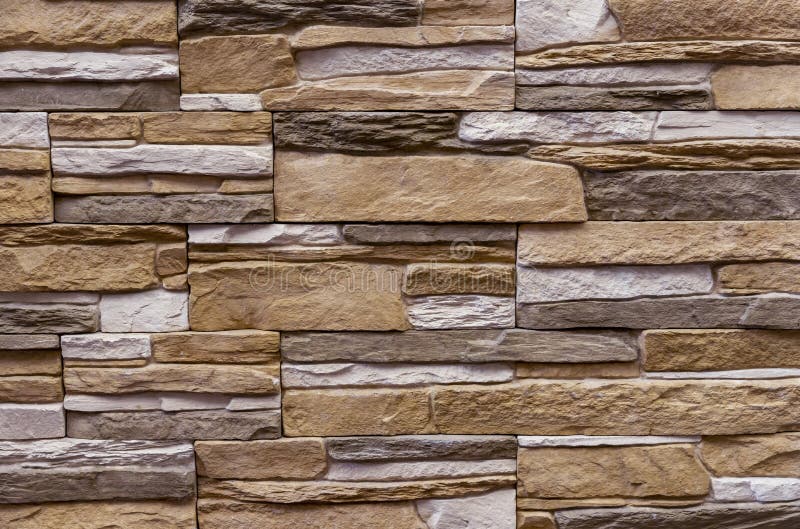 Texture of the stone wall. Panel of stones for finishing the facade of the building and interior design of the house. Background