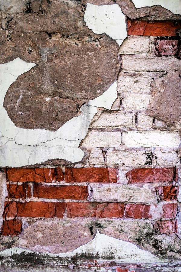 Texture of a Wall with Destroyed Bricks, Crumbling Plaster and Damaged