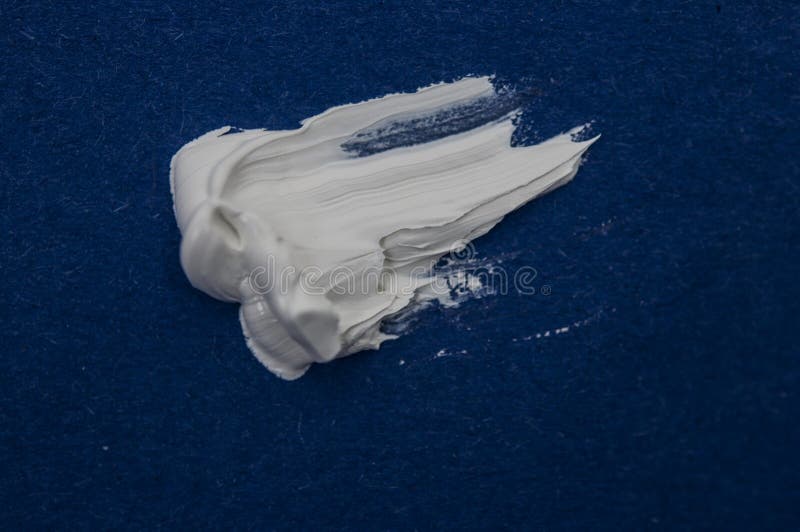 Structural Paint White on a Blue Background. Paint To Smear. Brush
