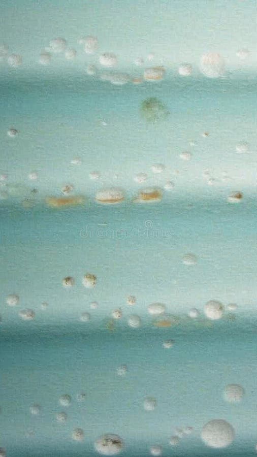 Textured light blue surface with water droplets and rust stains royalty free illustration