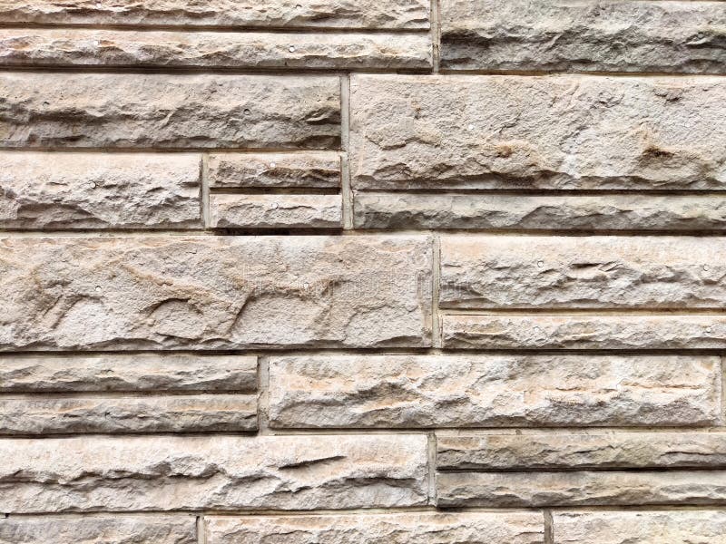 Textured wall design featuring layered stone patterns with ample space for customization and message placement. Surface showcases a rugged stone wall texture with irregular patterns, creating a versatile background for text or graphics.